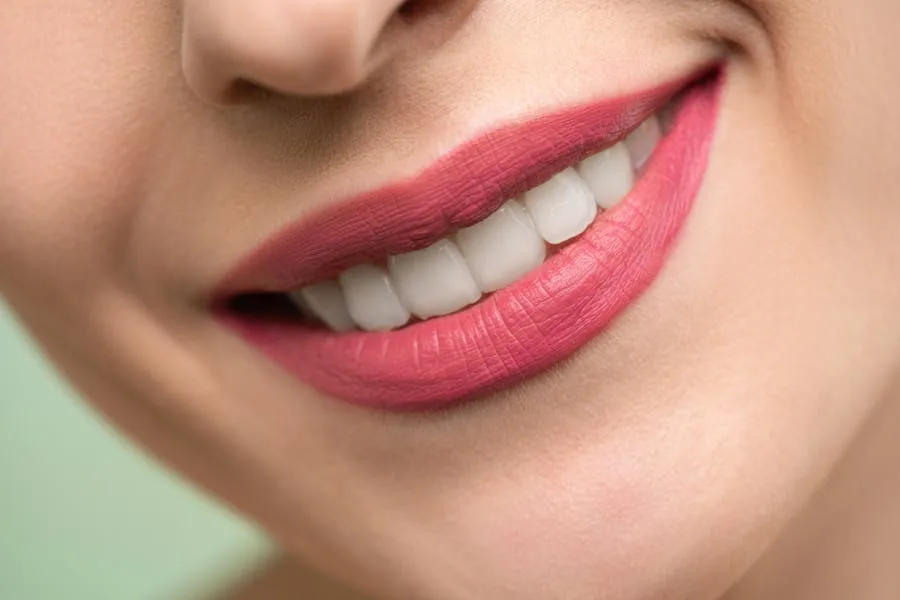 Woman smiling confidently after a cosmetic dental treatment